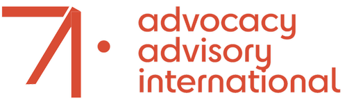 Advocacy Advisory International logo, stylized geometric orange symbol resembling number '7' or upward arrow on left, orange text on right reading 'advocacy advisory international' in modern sans-serif font, transparent background, contemporary organizational branding design.