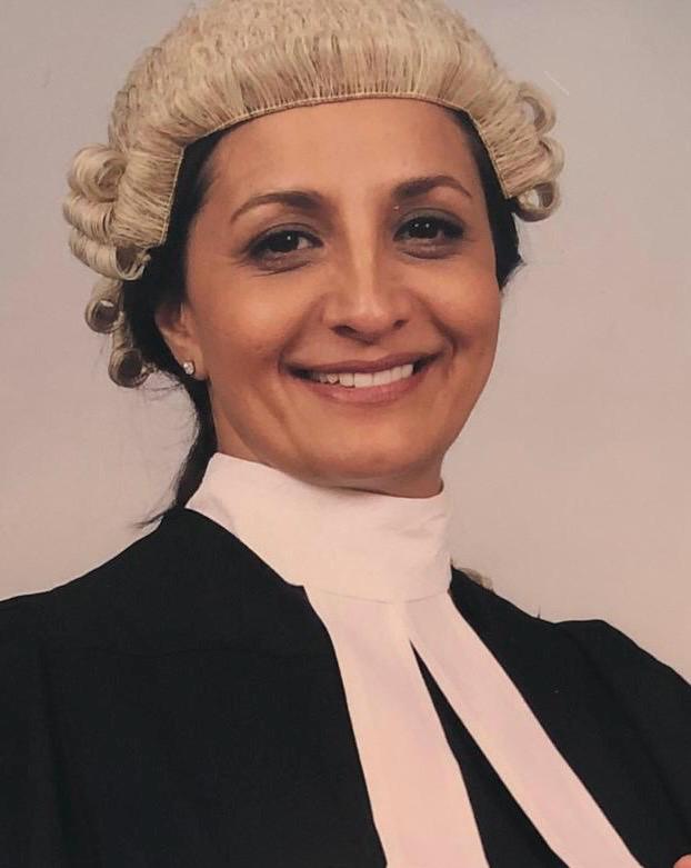 Layla Dean-Verity, Advocacy AI team member, in formal legal attire with white barrister’s wig, black robe, and white collar bands, against a plain neutral background, professional portrait style.